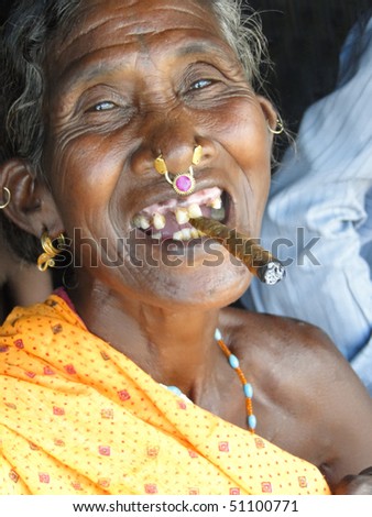 ORISSA,  INDIA - NOV 10  - Old woman smokes a cheroot in a tribal village  on Nov 10, 2009 in Orissa, India