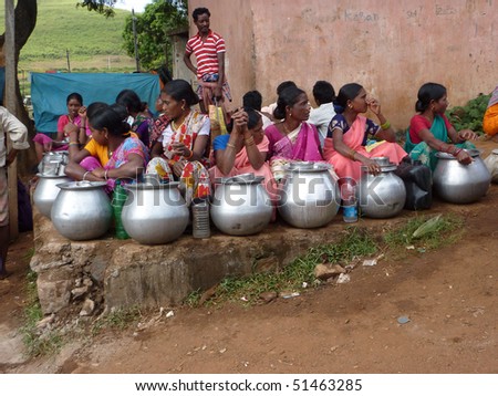 ORISSA,  INDIA - Nov 13 - Tribal women sell home brewed liquor from large metal pots   on Nov 13, 2009, in Orissa, India