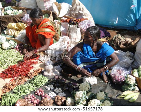 ORISSA,  INDIA - NOV 13  -	Indian villagers sell squash, cucumbers  and other vegetables	 on Nov 13, 2009 in Orissa, India