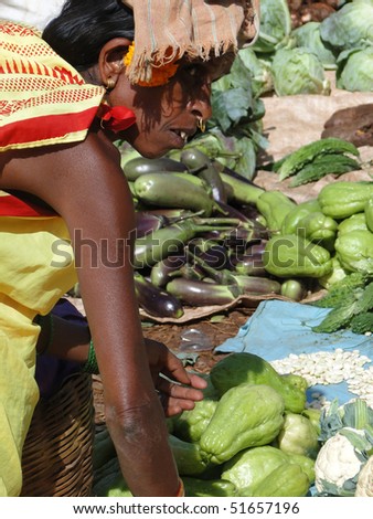ORISSA,  INDIA - NOV 13  -	Indian woman buying vegetables on Nov 13, 2009	in Orissa, India