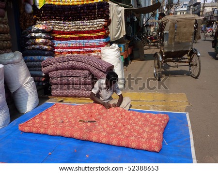 VARANASI, INDIA - NOV 7 -  Men sew large mattress covers in their shops   on Nov 7, 2009, in Varanasi, India.
