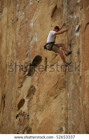SMITH ROCK STATE PARK, OREGON - MAY 20: Rock climber works his way up a sheer cliff face on May 20, 2007, in Central Oregon