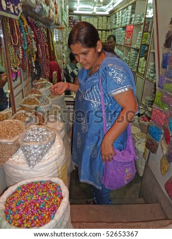 OLD DELHI, INDIA - NOV 3 : Indian woman in colorful saris browses the souvenir shops in the markets near Chandri Chowk on Nov 3, 2009, in Delhi, India.