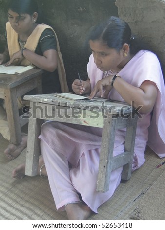 PURI, INDIA - NOV 15 : Student practices engraved calligraphy on palm leaves  on Nov 15, 2009  in Puri, India