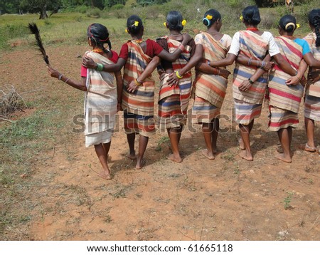 Village women link arms for Gdaba harvest dance in Lamptaput, Orissa, India