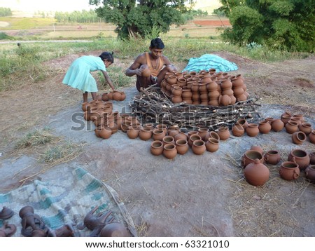 ORISSA,  INDIA - NOV 13 - Potter builds an outdoor kiln for clay pots on Nov 13, 2009, in Orissa, India