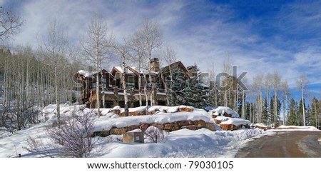 Large house in winter forest,  above Vail Valley,Colorado