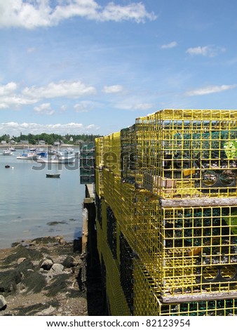 Lobster traps on wharf, with boats in Bernard harbor, Mount Desert Island, Maine