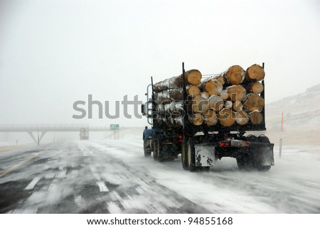 Logging truck on icy road  during winter storm in Eastern Oregon