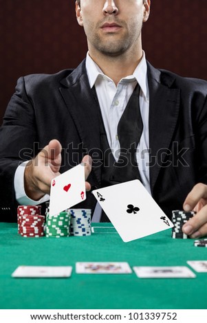 Poker player, on a red background, throwing two ace cards.