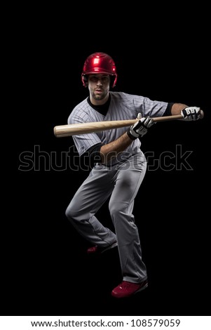 Baseball Player catching a ball on a black background.