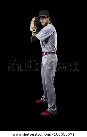 Baseball Player pitching a ball on a black background.