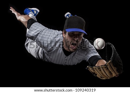 Baseball Player catching a ball on a blue uniform.