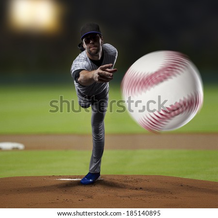 Pitcher Baseball Player on a Blue Uniform on baseball Stadium.