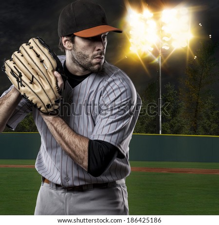Baseball Player on a Orange Uniform on baseball Stadium.