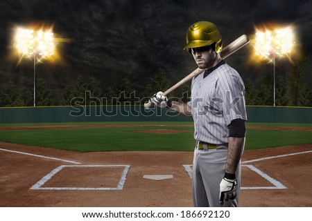 Baseball Player on a Yellow Uniform on baseball Stadium.