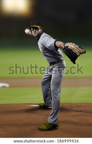 Pitcher Baseball Player on a Yellow Uniform on baseball Stadium.