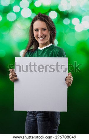 Female Mexican Fan holding a blank sign on a green lights background.