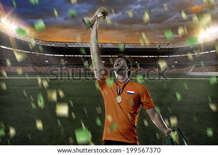 Dutchman soccer player, celebrating the championship with a trophy in his hand. On a Stadium.