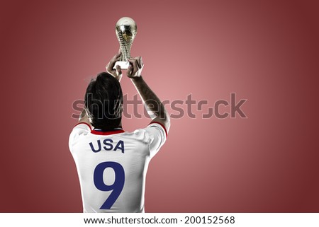 American soccer player, celebrating the championship with a trophy in his hand. On a red background.