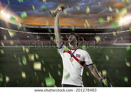 costa rican soccer player, celebrating the championship with a trophy in his hand. On a stadium.