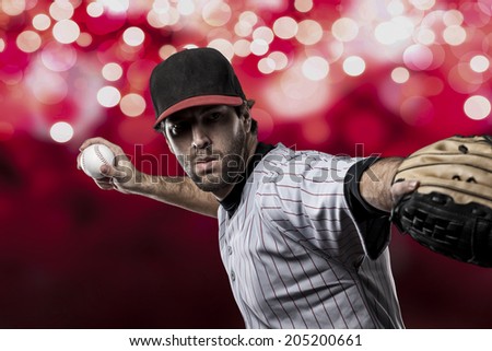 Baseball Player on a Red Uniform on red lights background.