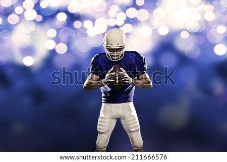 Football Player on a Blue uniform, on a Blue lights background.