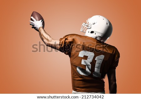 Football Player on a Orange uniform celebrating on a orange background.