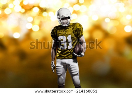 Football Player on a yellow uniform, on a yellow lights background.