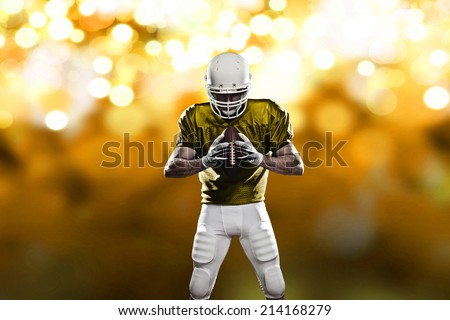 Football Player on a yellow uniform, on a yellow lights background.