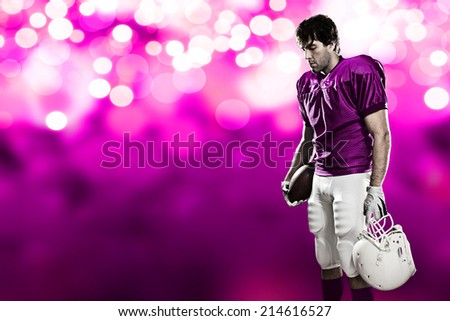 Football Player on a pink uniform, on a pink lights background.