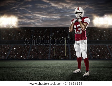 Football Player with a red uniform on a stadium.