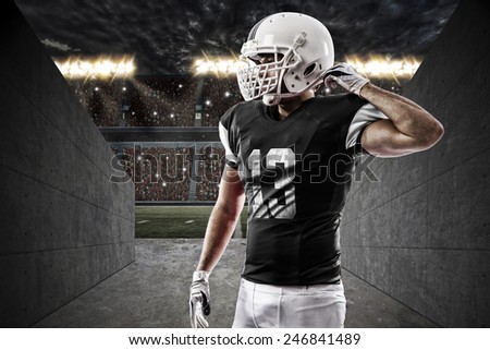 Football Player with a Black uniform on a stadium tunnel.