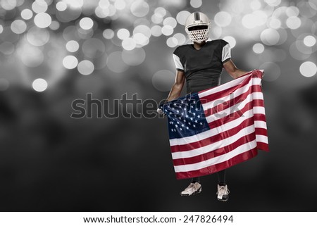 Football Player with a black uniform and a american flag, on a black lights background.