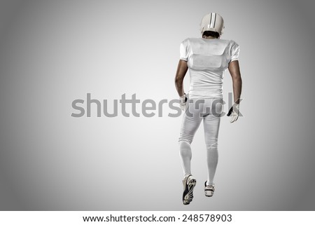 Football Player with a white uniform walking, showing his back on a white background.