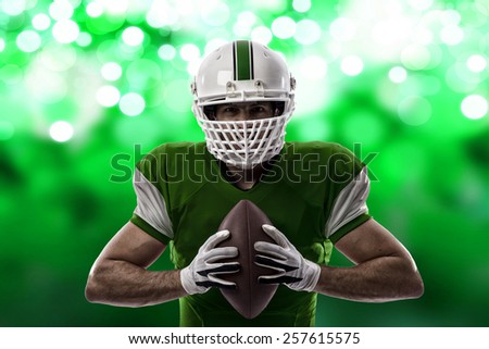 Football Player with a green uniform on a green lights background.