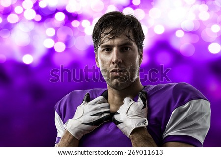 Football Player with a purple uniform on a purple lights background.