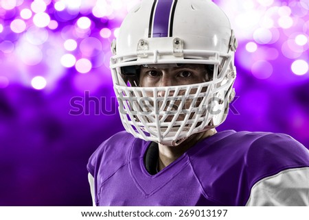 Close up of a Football Player with a purple uniform on a purple lights background.