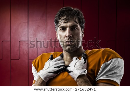 Football Player with a orange uniform on a Locker roon.