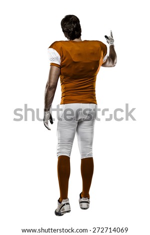 Football Player with a orange uniform walking, showing his back on a white background.