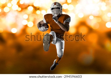 Football Player with a orange uniform Running on a orange lights background.