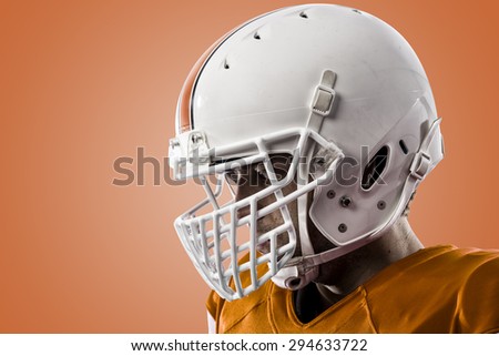 Close up of a Football Player with a orange uniform on a orange background.