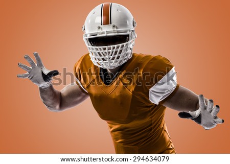 Football Player with a orange uniform making a tackle on a orange background.