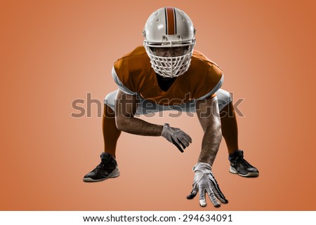 Football Player with a orange uniform on the scrimmage line, on a orange background.
