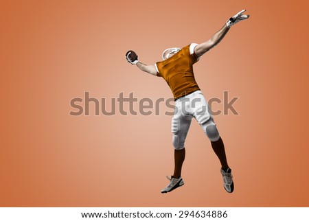 Football Player with a orange uniform making a catch on a orange background.
