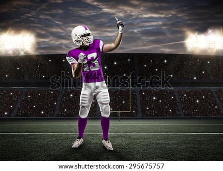 Football Player with a pink uniform making a selfie on a stadium.