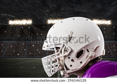 Close up of a Football pink with a white uniform on a stadium.