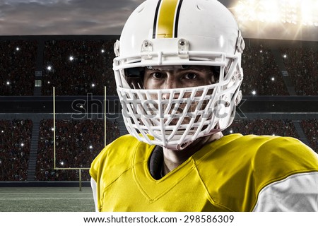 Close up of a Football yellow with a white uniform on a stadium.