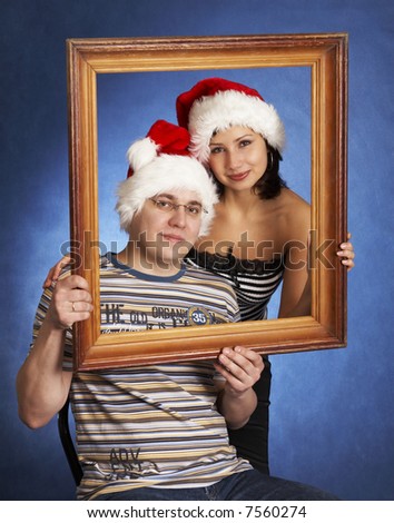 happy family wearing Santa Claus hats and picture frame