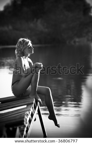 black and white picture of a woman in a swim suite outdoors